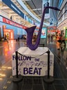 Purple saxophone sculpture follow the beat in arrivals hall at Vienna International Airport