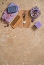 Purple sea salt, a wooden comb towel on a concrete brown background. Royalty Free Stock Photo