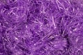 Purple shredded plastic fake Easter grass background