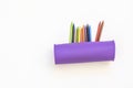 a purple silicone pencil case filled