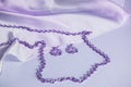 Purple silk, draped waves, silver chain and earrings, toned image in lilac, luxury accessories for women, background for jewelry
