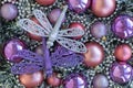Purple and silver dragonflies on purple and violet Christmas balls. Christmas background. New Year concept Royalty Free Stock Photo
