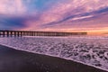 Purple sky over long pier and foamy waves at sunset, Ventura beach, California, USA Royalty Free Stock Photo