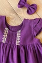 Purple sleeveless dress made of linen fabric. Baby Dress