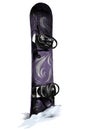 Purple snowboard with white pattern stuck in a snowdrift and sticking out of snow Royalty Free Stock Photo