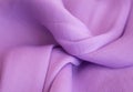 Purple soft fabric in light folds layout with sun highlights and shadows. Summer concept, femininity in trend, flatlay Royalty Free Stock Photo