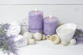 Purple spa setting with burning candles and potpourri. Spa still life Royalty Free Stock Photo