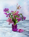 Purple spring bouquet flowers in a glass vase Royalty Free Stock Photo