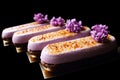 Purple spring Creme Brulee desserts with fresh lilac flowers isolated on black background Royalty Free Stock Photo