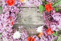 Purple Spring Lilac Frame over rustic Textured Wooden Board Copy space