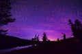 Purple Stary Night Sky Over Forest and Lake Royalty Free Stock Photo