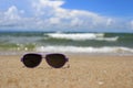 Purple Sunglasses on sand at Beach. Royalty Free Stock Photo