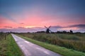 Purple sunrise over Dutch farmland with windmill Royalty Free Stock Photo