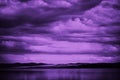 Purple sunset. Sky with clouds over the sea. Dramatic. Mountains on the horizon. Beautiful toned landscape Royalty Free Stock Photo