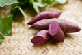 Purple sweet potato and leaf on weave wooden basket