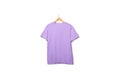 Purple t-shirt on wooden hanger floating on plain background Royalty Free Stock Photo