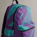 Purple and teal backpack with modern geometric patterns. Features a front pocket, Royalty Free Stock Photo