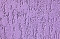 Purple textured wall, background. Plastered building wall, painted with violet water-based paint. Decorated surface Royalty Free Stock Photo