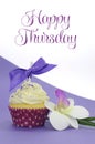 Purple theme cupcake with orchid flower with Happy Thursday sample text Royalty Free Stock Photo