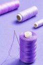 Purple thread bobbin and needle.Useful as tailor background Royalty Free Stock Photo