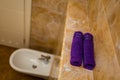 Purple towels in the bathroom in rolls Royalty Free Stock Photo