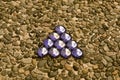 Purple triangle on pebblestone background Royalty Free Stock Photo