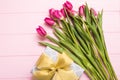 Purple tulip bouquet and gift boxes. Top view over pink wooden table Royalty Free Stock Photo