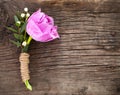 Purple tulip buttonhole for groom on the wooden background Royalty Free Stock Photo