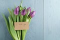 Purple tulips on blue wood background with i love you card top view Royalty Free Stock Photo