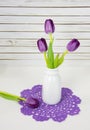 Purple tulips in retro bottle Royalty Free Stock Photo