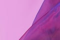 Purple tulle netting fabric with blue hue on side of pink background Royalty Free Stock Photo