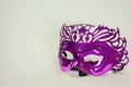 Purple venetian mask on white background for masquerade ball carnival Royalty Free Stock Photo