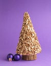 Purple vintage Christmas baubles with a golden tree shape on a purple background Royalty Free Stock Photo