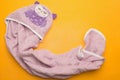 Purple violet bathing baby towel on a yellow background. view f Royalty Free Stock Photo