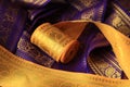 Purple violet and yellow Indian Sari border with gold paisley pattern. purple yellow background Royalty Free Stock Photo