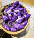 Purple water bottles in jute sack for sale