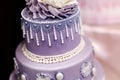 Purple wedding cake decorated with flowers Royalty Free Stock Photo