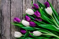 Purple and white tulips bouquet on a rustic wooden background Royalty Free Stock Photo