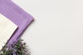 Purple and white waffle towels, floral plant on gray background with copy space and place for text