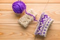 Purple and white woolen yarn and knitted socks with a pattern Royalty Free Stock Photo