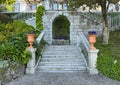 Purple wild pansies in a terracotta planters flanking steps in the Garden of the Villa Cipressi in Varenna.