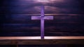 Purple wooden cross on an empty pew in the church