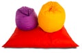 Purple and yellow beanbag chairs on red beanbag sofa Royalty Free Stock Photo
