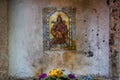 Small religious altar on dirty white wall