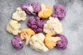 Purple yellow and white cauliflower, on gray stone table background, top view flat lay Royalty Free Stock Photo