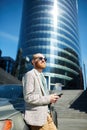 Purposeful entrepreneur leaning on car