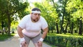 Purposeful fat man running in park, out of breath, persistent motivation Royalty Free Stock Photo