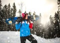 Purposeful woman with snowboard in snowfall winter on pine