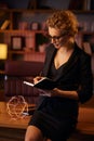 Purposeful young business woman, professional entrepreneur, reads a book. Business woman in a beautiful office in