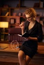 Purposeful young business woman, professional entrepreneur, reads a book. Business woman in a beautiful office in